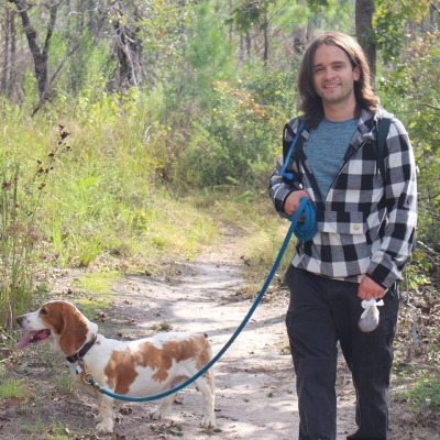josh with dog at a park outside