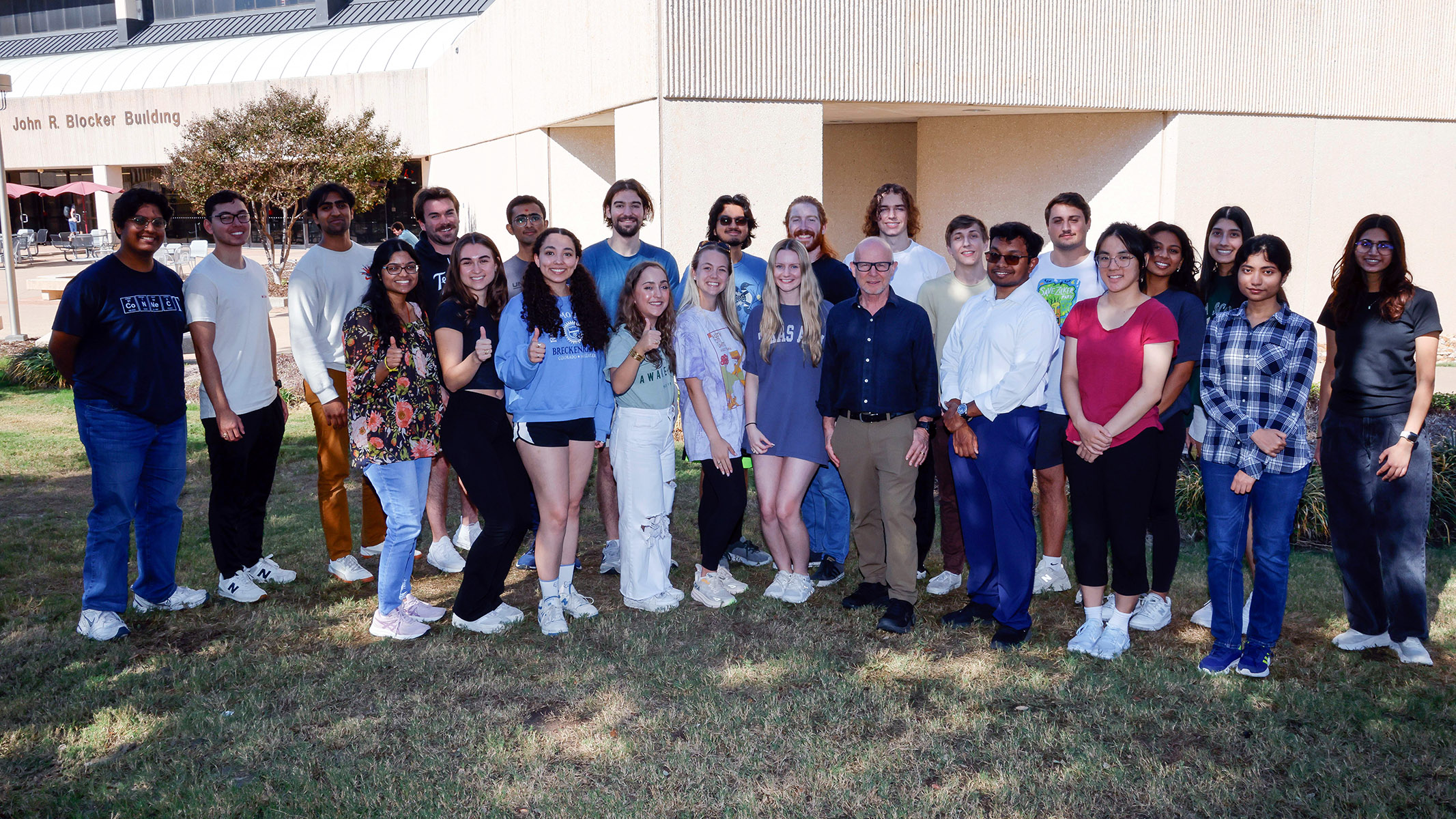 Dr. Matthew Sachs (center), posing with members of the fall 2024 BIOL 495 class outside the John R. Blocker Building on the Texas A&amp;M campus.