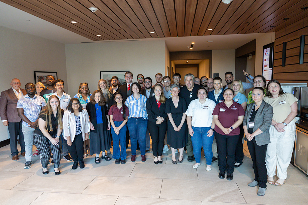 group photo indoors at Harthcock Symposium