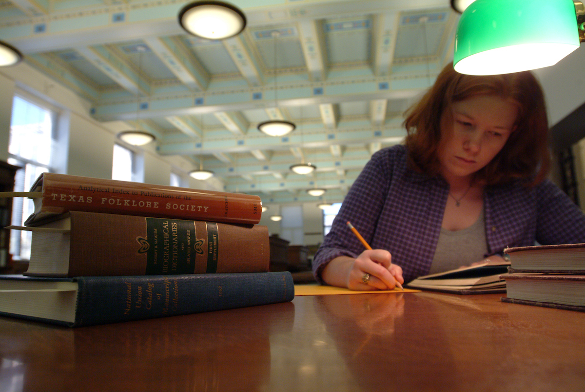 A student engaged in research in a library.