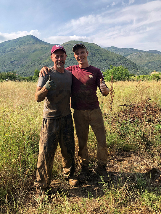 Tristan Krause at an excavation of a B-26 crash in mainland Italy.  Pictured also is Dan Debree, a US Air Force veteran and professor of practice at the Bush school.  This excavation was led by the Cranfield Recovery and Identification of Conflict Casualties team in partnership with the U.S. Department of Defense POW/MIA Accounting Agency.