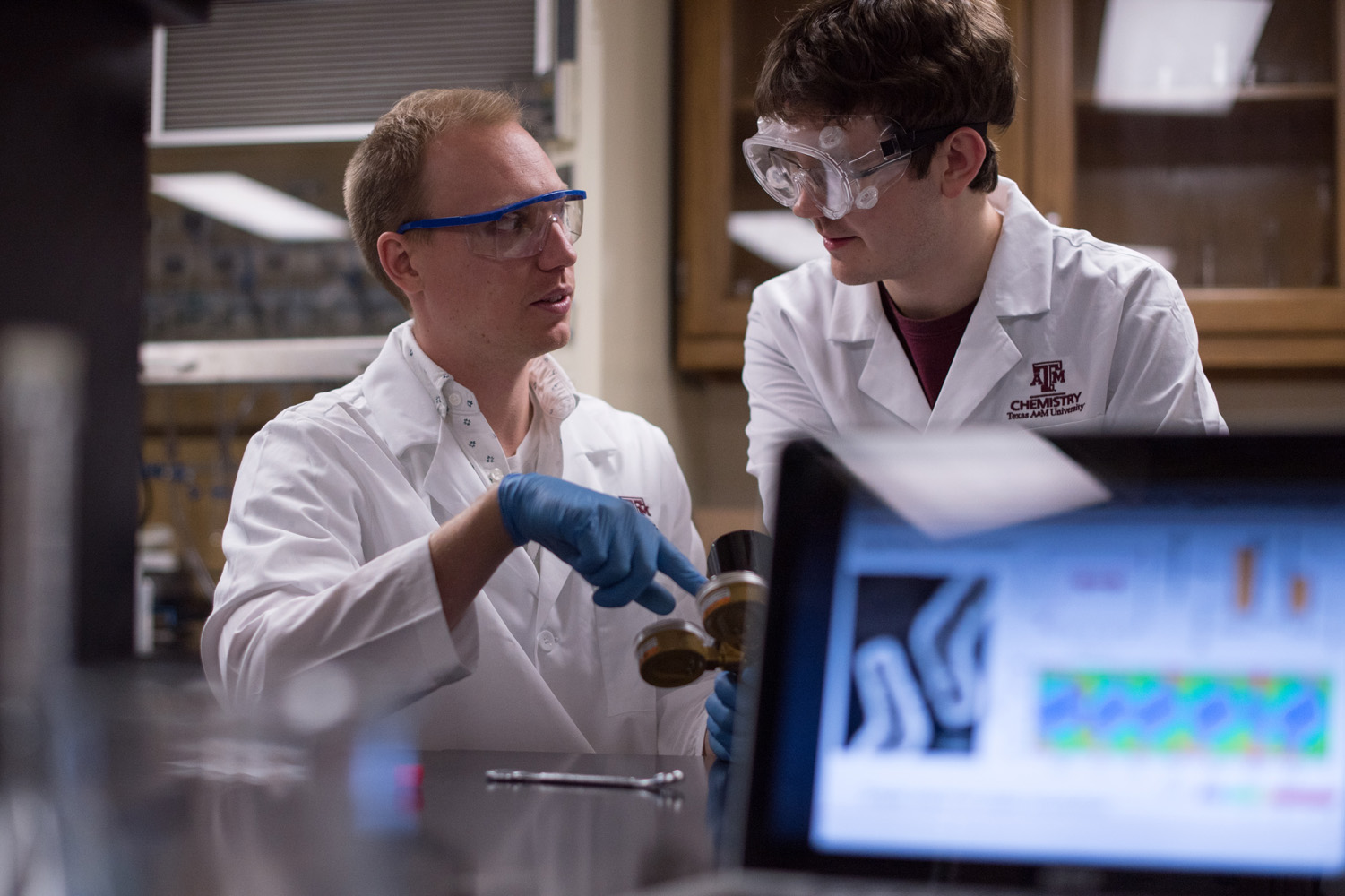 Dr. Matthew Sheldon gives instructions as he points to a specimen in his chemistry lab