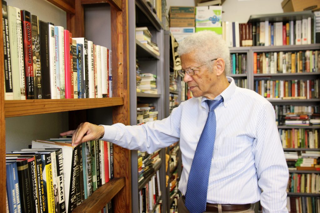 Man reaching for a book 