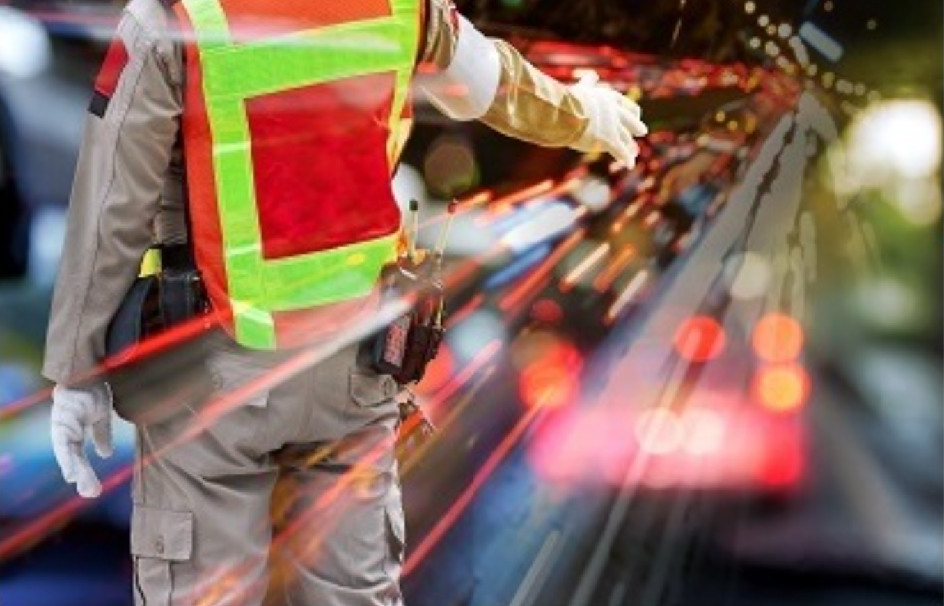 Stock photo of a first responder directing traffic