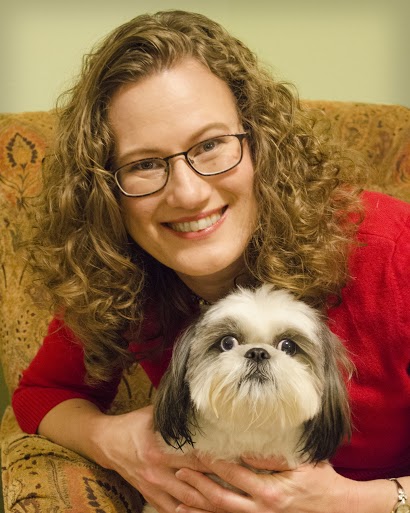 Texas A&amp;M faculty smiling with his dog