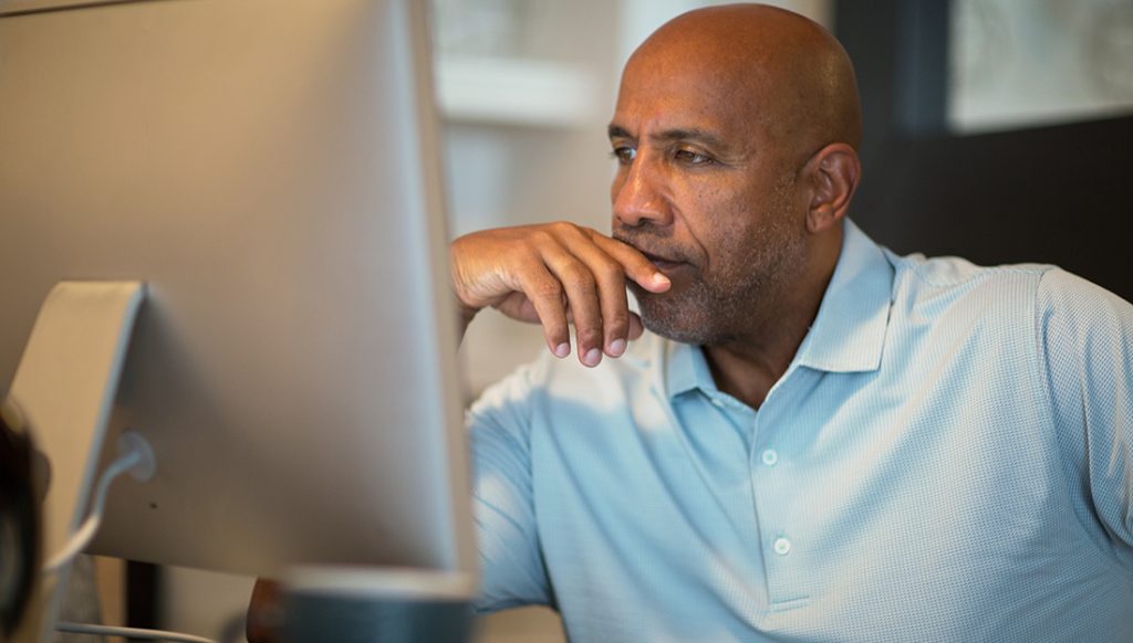 Man looking at his computer