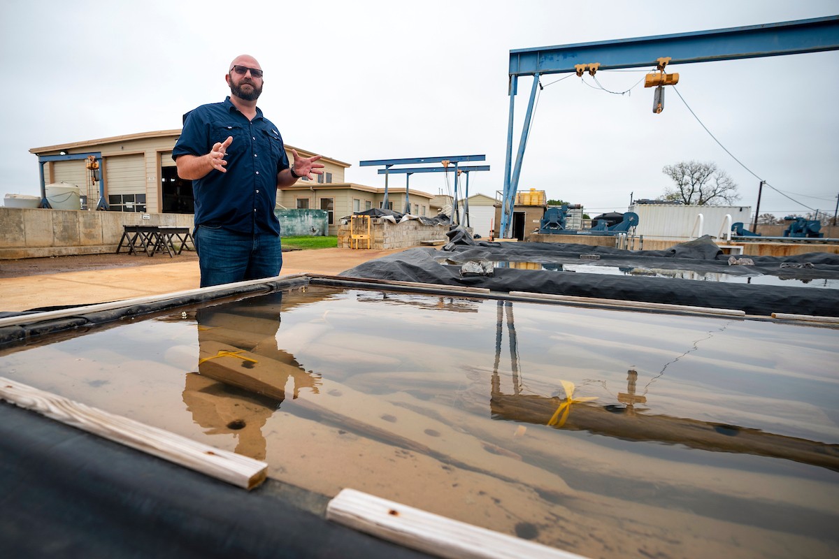 Texas A&amp;M nautical archaeologist Chris Dostal stands next to the submerged remains of a colonial-era shipwreck