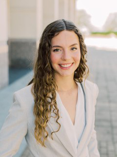 Texas A&amp;M senior Grace Vaughn is all smiles, standing outside the Jon L. Hagler Center on the Texas A&amp;M University campus