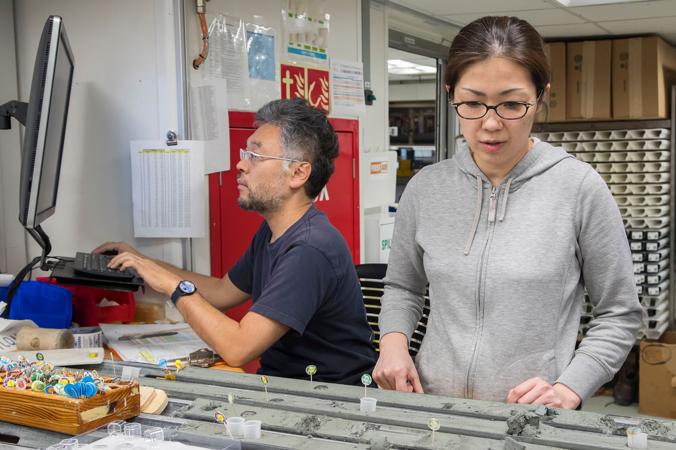 Texas A&amp;M geologist Hiroko Kitajima examines core samples taken from the ocean floor while onboard the JOIDES Revolution