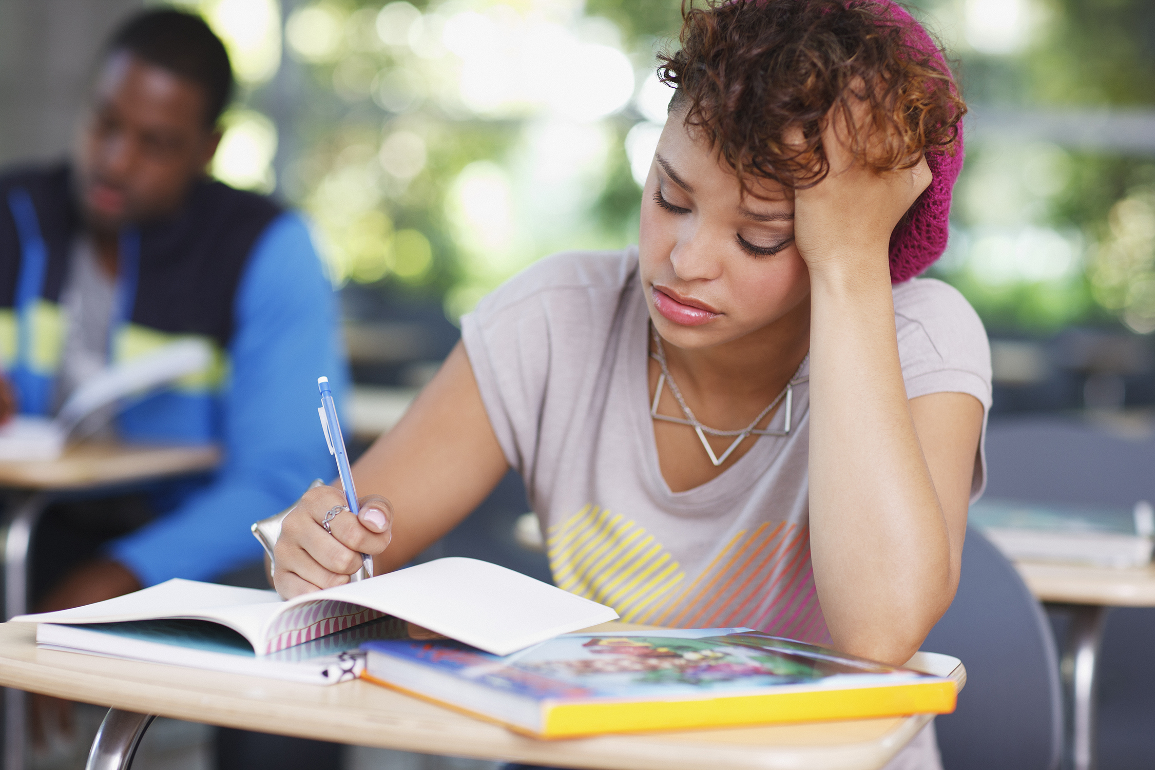 Frustrated student at work in a classroom