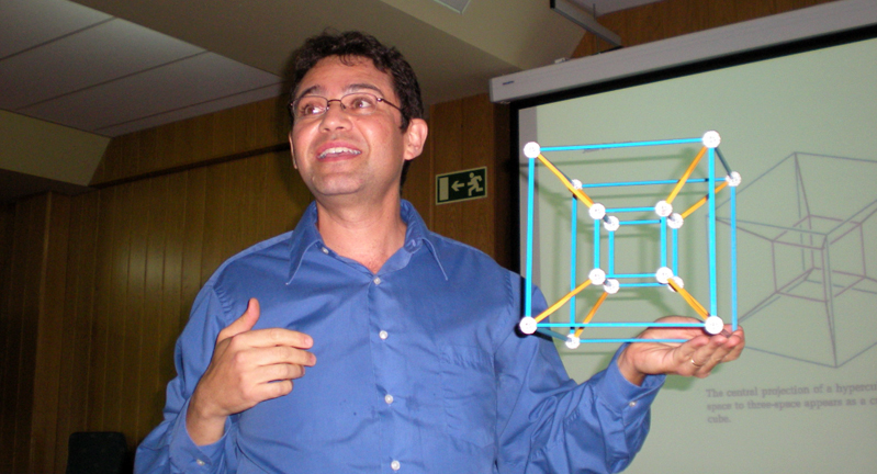 University of California, Davis, mathematician Jesus De Loera holds a cube as he presents his research on