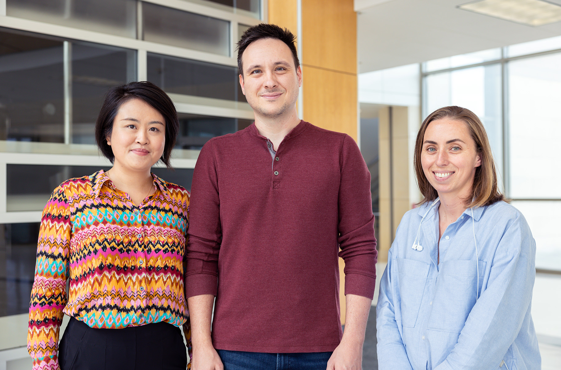 Texas A&amp;M University biologists Wanhe Li, Jeff Jones and Kira Delmore smile for the camera within the Interdisciplinary Life Sciences Building