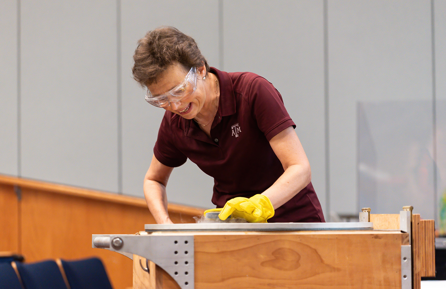 Texas A&amp;M physicist Tatiana Erukhimova places a plastic locomotive on a metal track cooled by liquid nitrogen