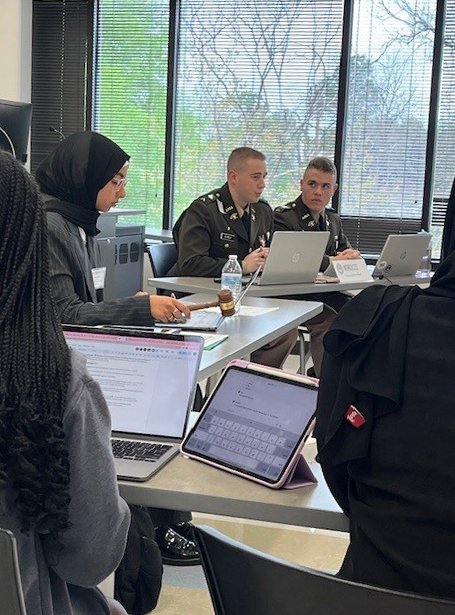 Two Texas A&amp;M University team members (far right), acting as diplomats for Morocco and interacting with other diplomats during the 2024 Model Arab League Conference, held March 2-3 in Houston