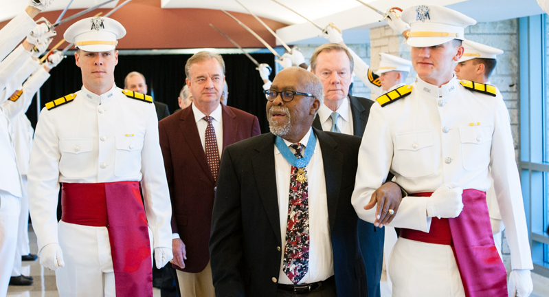 Texas A&M University chemistry former student and Congressional Medal of Honor recipient Clarence Sasser, flanked by Ross Volunteers as he walks through the Memorial Student Center