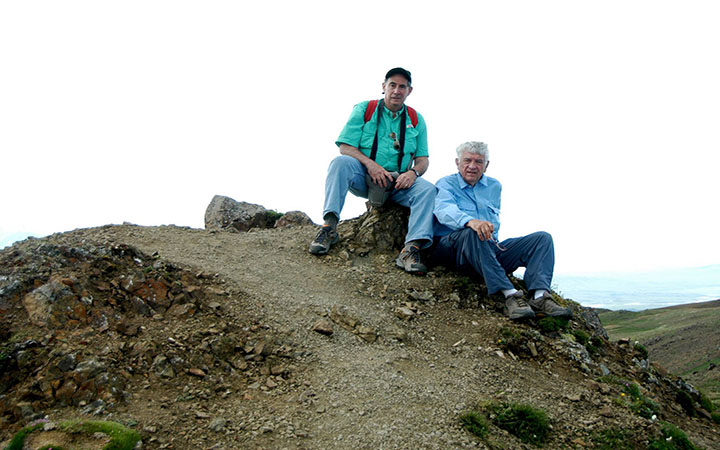 Texas A&amp;M University professors Rick Giardino and Jack Vitek sit atop a small hill while taking a break from leading a G-Camp excursion