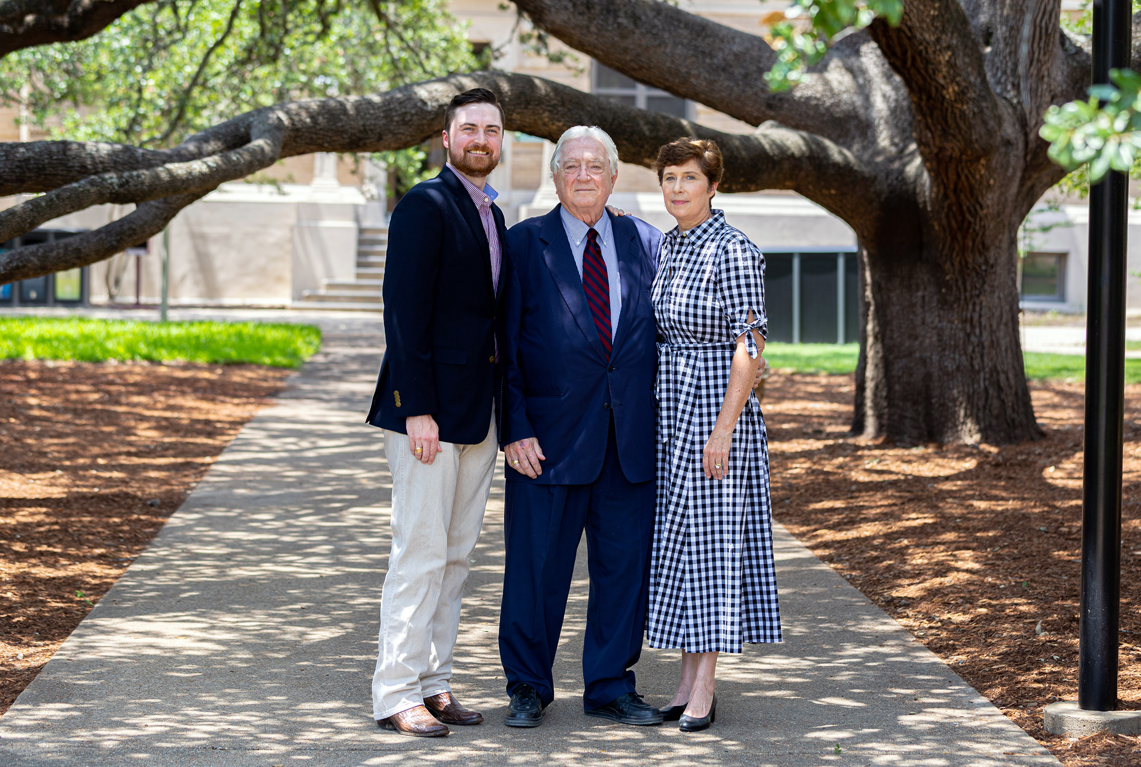 Luther, Luke and Andrea Soules stand under the Century Tree on the Texas A&amp;M University campus