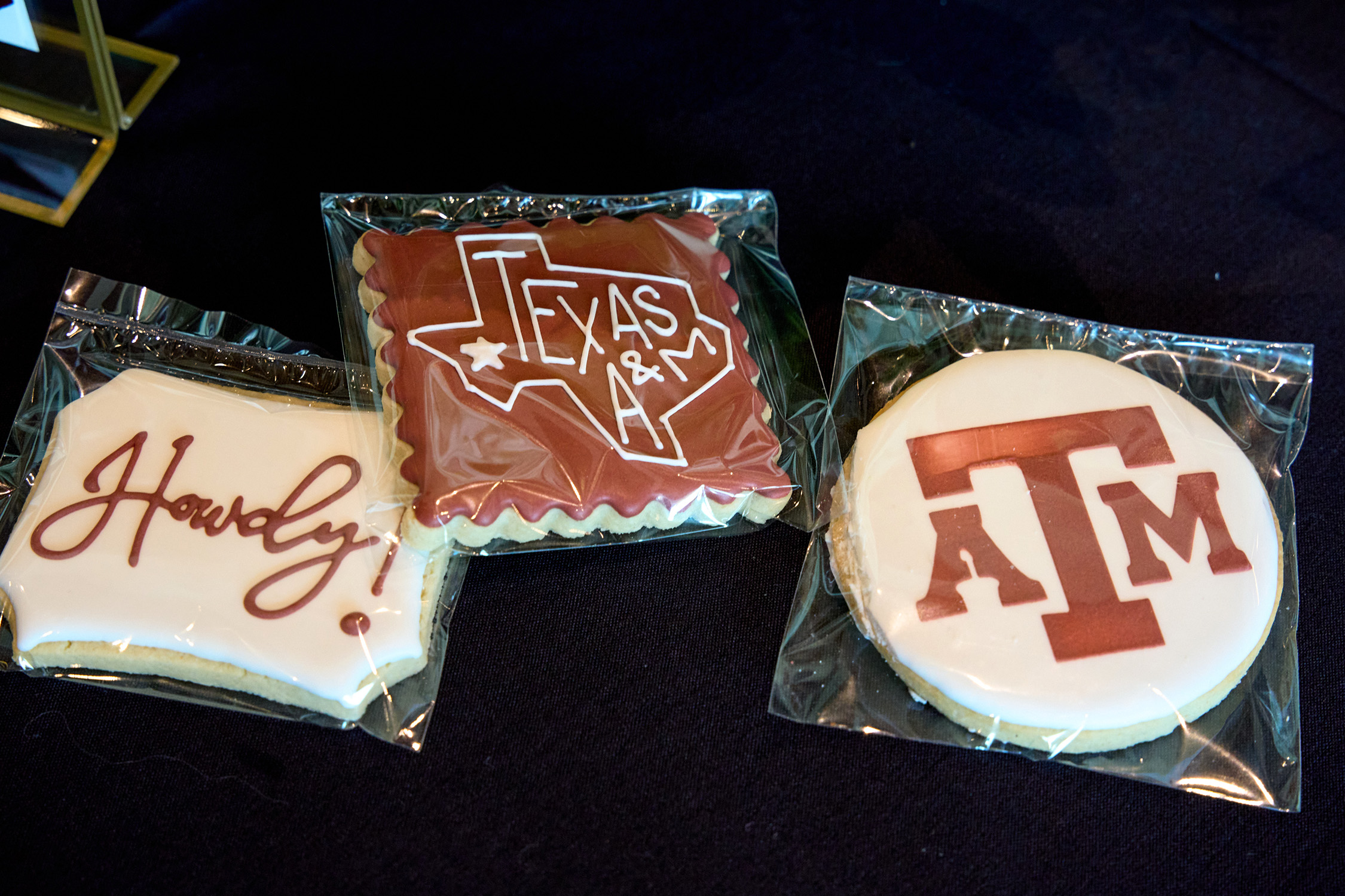 Custom-decorated cookies featuring maroon and white icing and the words "Howdy" and "Texas A&amp;M" and the Texas A&amp;M logo