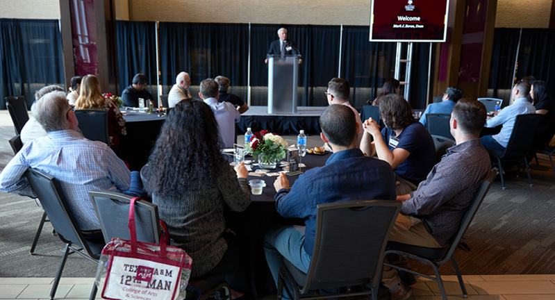 Texas A&amp;M University College of Arts and Sciences Dean Mark Zoran addresses the crowd from behind the podium in the All-American Club at Kyle Field during the 2024 College of Arts and Sciences New Faculty Welcome Reception on September 12, 2024