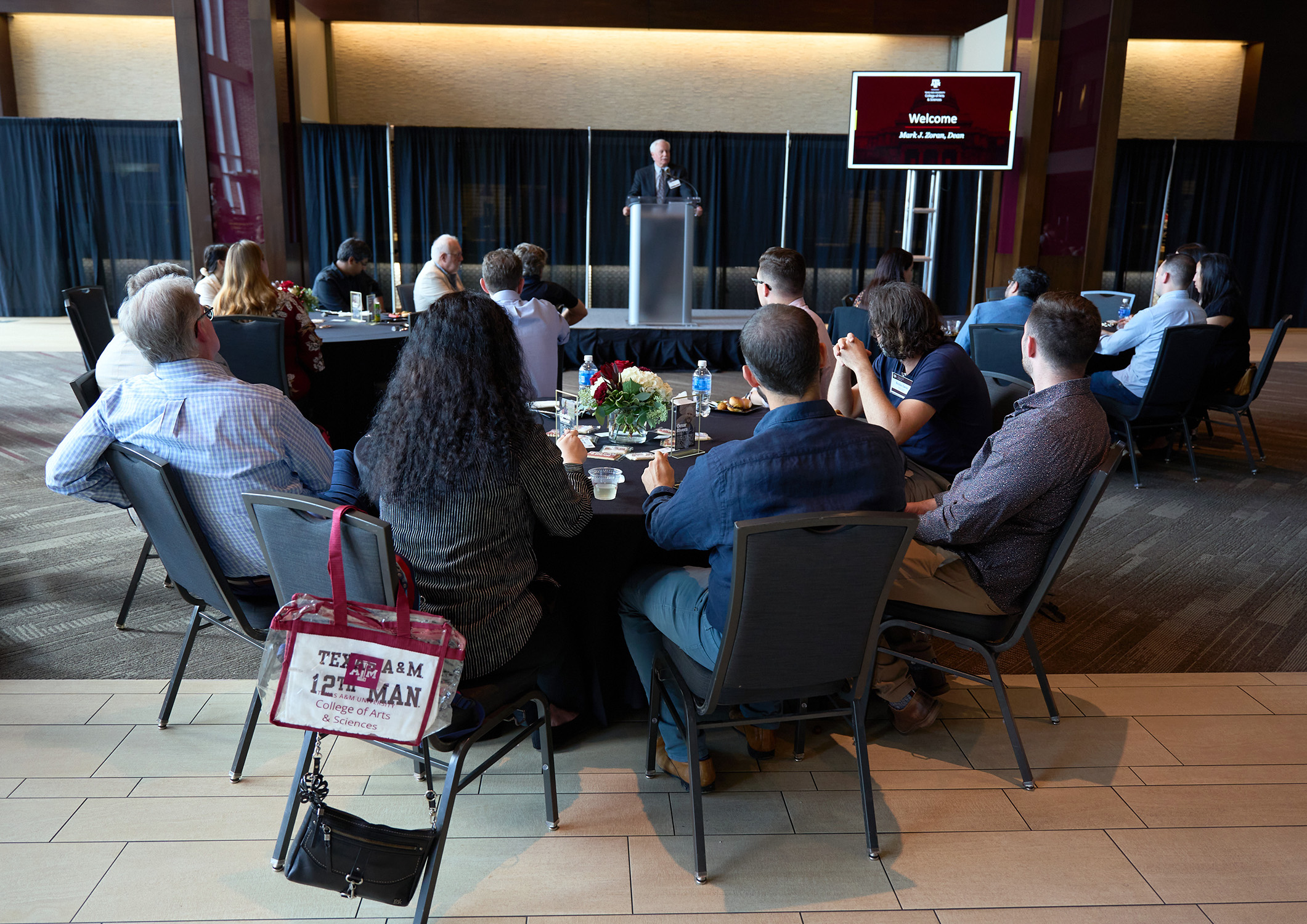 Texas A&amp;M University College of Arts and Sciences Dean Mark Zoran addresses the crowd from behind the podium in the All-American Club at Kyle Field during the 2024 College of Arts and Sciences New Faculty Welcome Reception on September 12, 2024