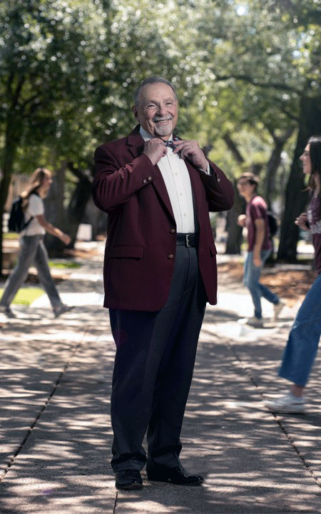 1970 Texas A&amp;M University physics graduate R. Bowen Loftin adjusts his bowtie while standing in Academic Plaza on the Texas A&amp;M campus