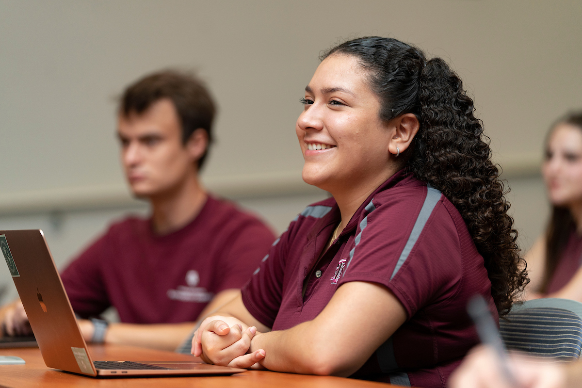 female student smiling in classroom