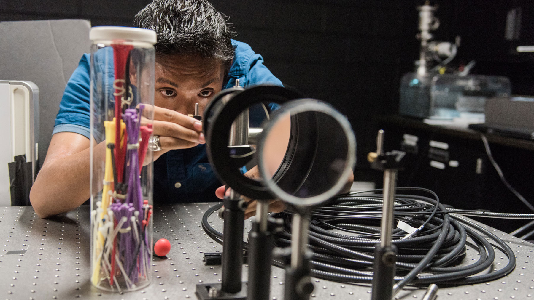 A graduate student working with equipment in a lab.