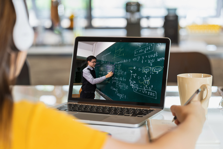 Student observing class content via a laptop